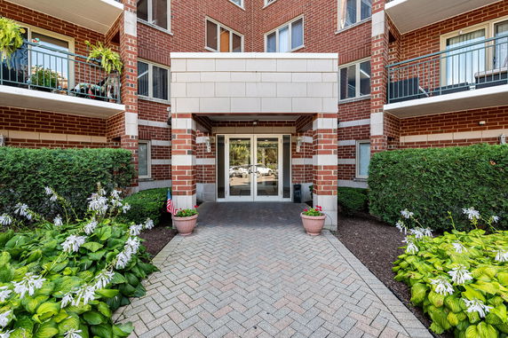 Front view of a building entrance with brick exterior and covered entryway.