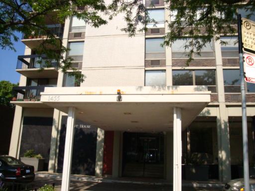 Front view of a multi-story building with a covered entrance.