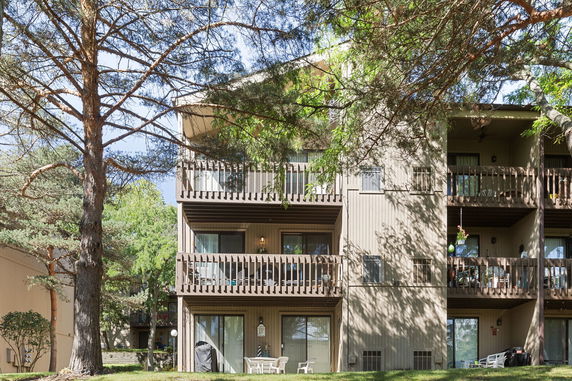 Front view of a multi-story building with balconies on each floor.