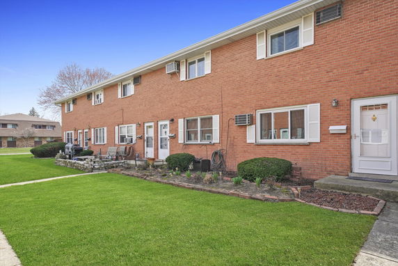 Front view of a two-story brick apartment building.