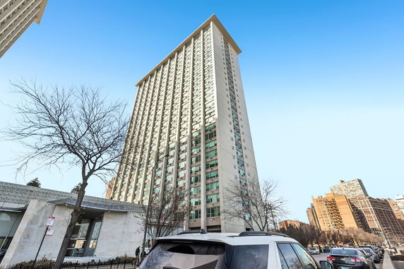 Front view of a tall high-rise apartment building.