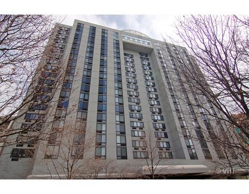 Front view of a multi-story modern building with tall windows.