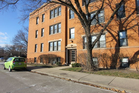 Front view of a three-story brick apartment building.