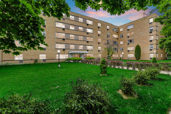Front view of a multi-story brick apartment building.