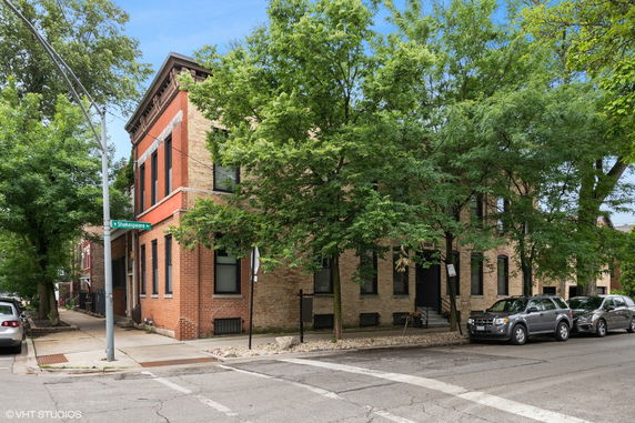 Front view of a brick building on a street corner.