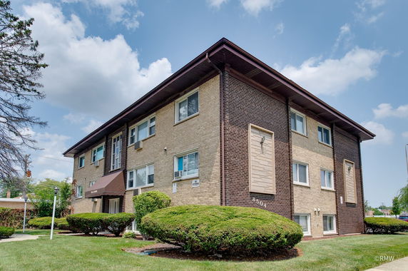 Front view of a two-story brick apartment building.