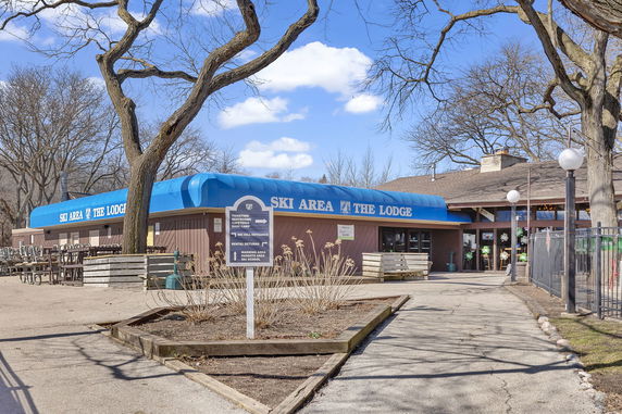 Front view of a building labeled 'Ski Area The Lodge' with a blue awning.