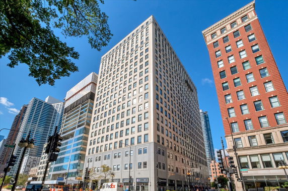 Front view of a tall office building in an urban setting.