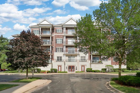 Front view of a multi-story residential building with balconies.