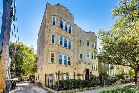 Front view of a three-story brick apartment building.