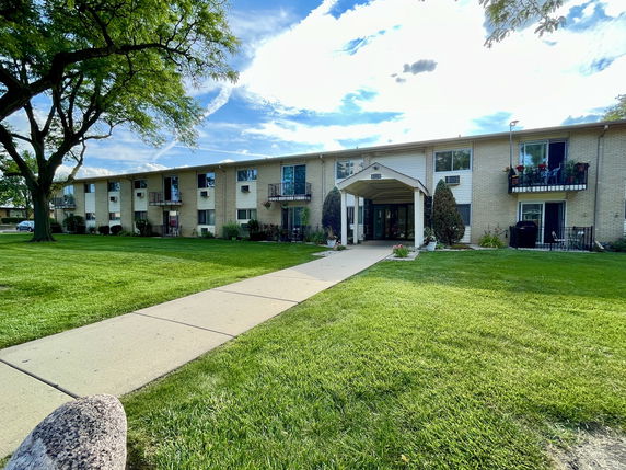 Front view of a two-story residential building with balconies.