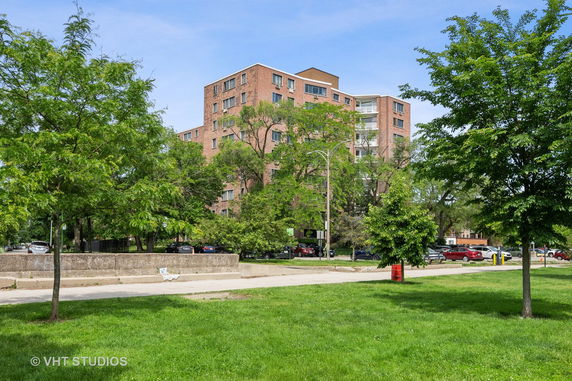Front view of a multi-story brick apartment building.
