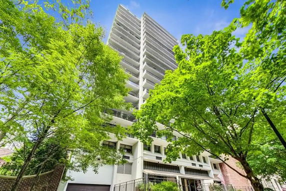 Front view of a high-rise building with multiple balconies.