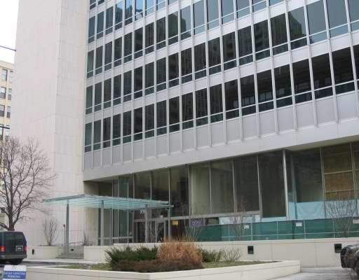 Front view of a multi-story office building with a glass facade.