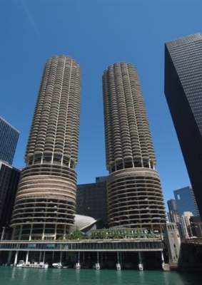 Front view of two cylindrical multi-story buildings with a unique architectural design.