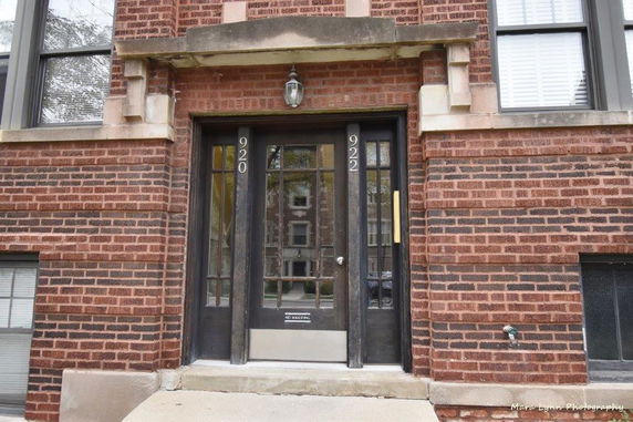 Front view of a brick building entrance with two doors.