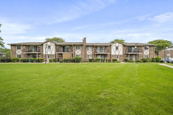 Front view of a two-story apartment building with brick exterior.