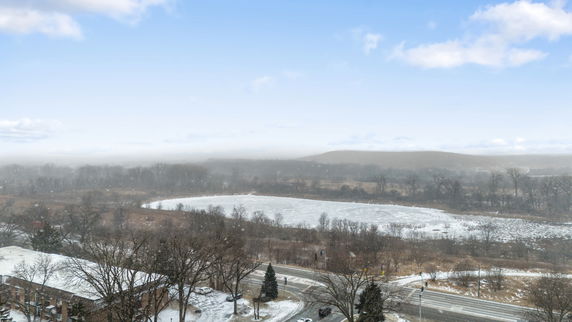 Panoramic view of a snowy landscape with a frozen lake and roads.