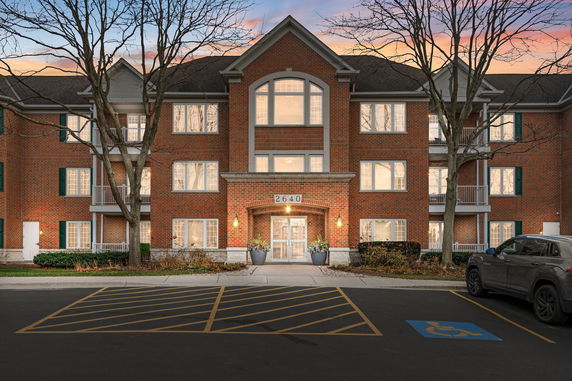 Front view of a three-story brick building with multiple windows and a central entrance.