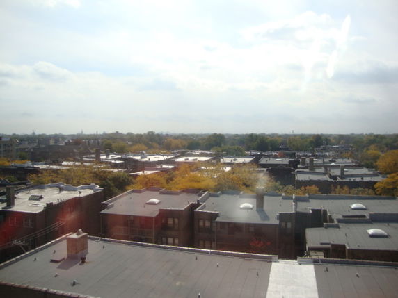 Wide angle view of rooftops and surrounding area.