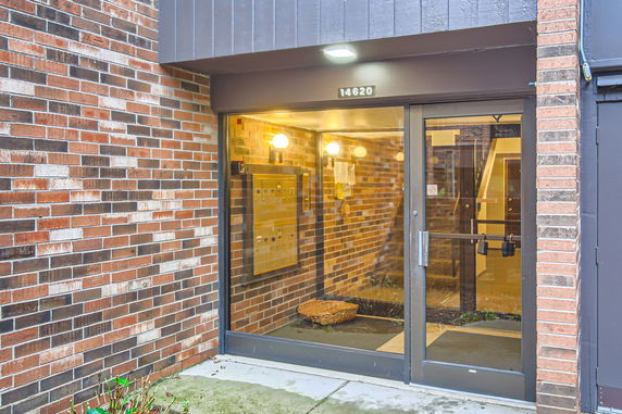 Front entrance of a brick building with glass double doors.