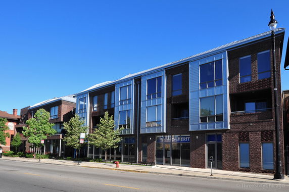 Front view of a modern multi-story building with large windows.