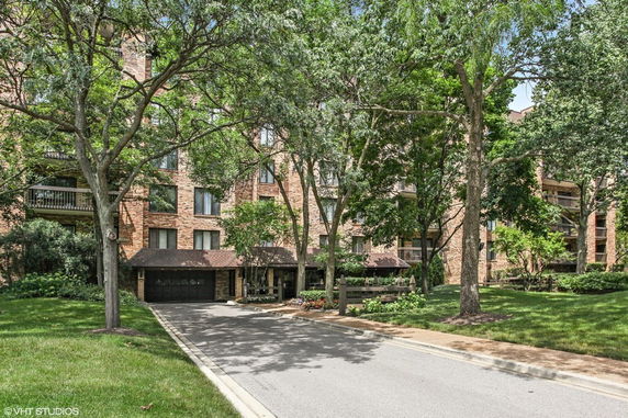 Front view of a multi-story brick building with balconies.