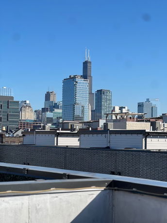 Panoramic view of a cityscape with tall skyscrapers on a clear day.