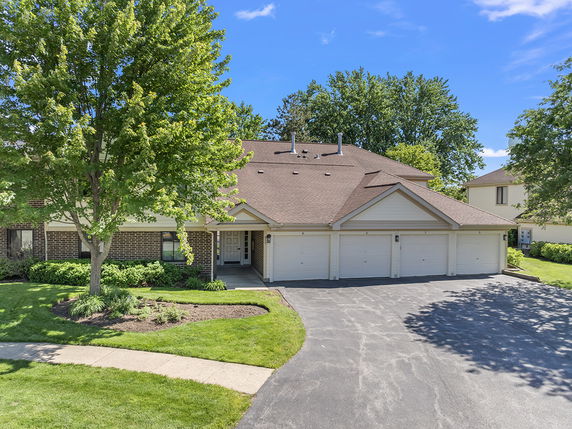 Front view of a multi-unit residential building with attached garage.