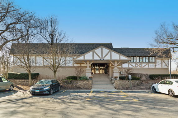Front view of a building with a pitched roof and symmetrical design.