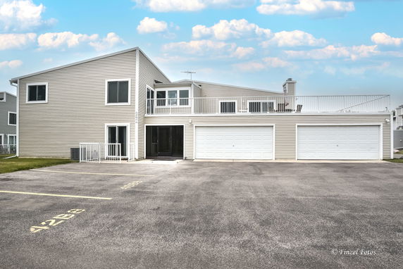 Front view of a two-story house with a triple garage.