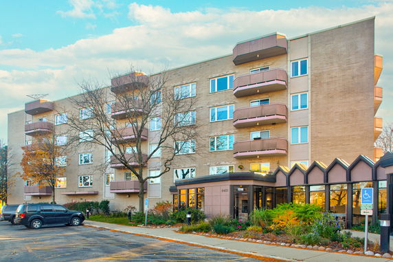 Front view of a multi-story apartment building with balconies.