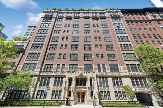 Front view of a multi-story brick building with ornate entrance.