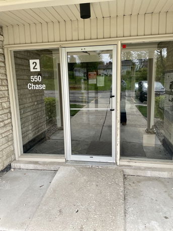 Front view of a building entrance with glass doors.