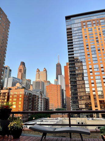 Urban panoramic view with a mix of tall buildings and a clear blue sky.