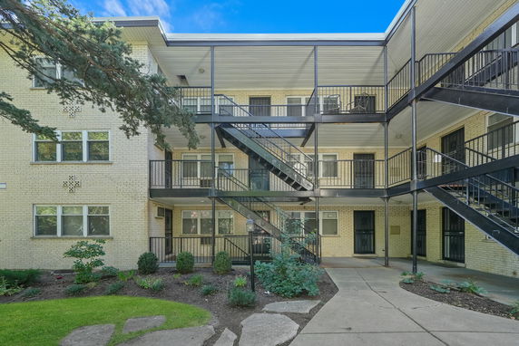 Front view of a multi-story building with external staircases.