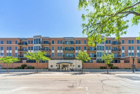 Front view of a multi-story apartment building with a central entrance.