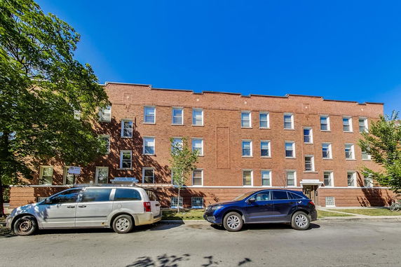 Front view of a three-story brick apartment building.