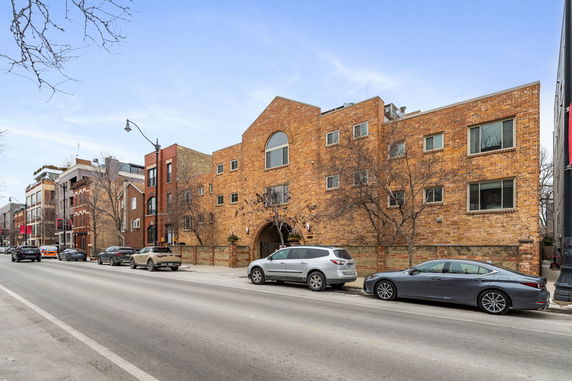 Front view of a multi-story building with brick facade.