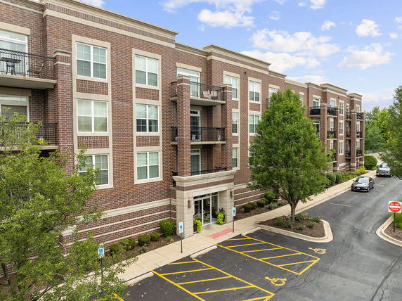 Front view of a multi-story brick apartment building.