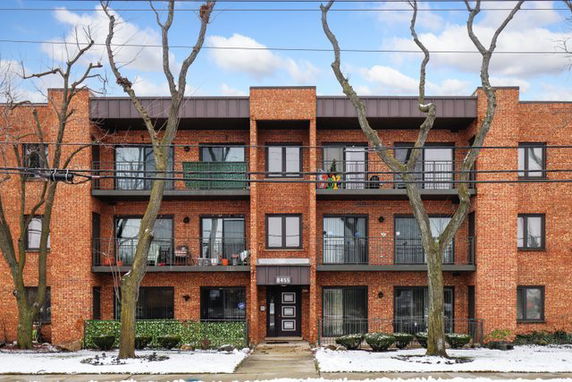 Front view of a three-story brick apartment building.
