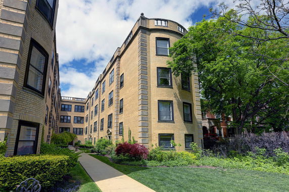 View of a multi-story brick apartment building.