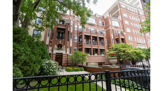 Front view of a multi-story brick building with balconies.