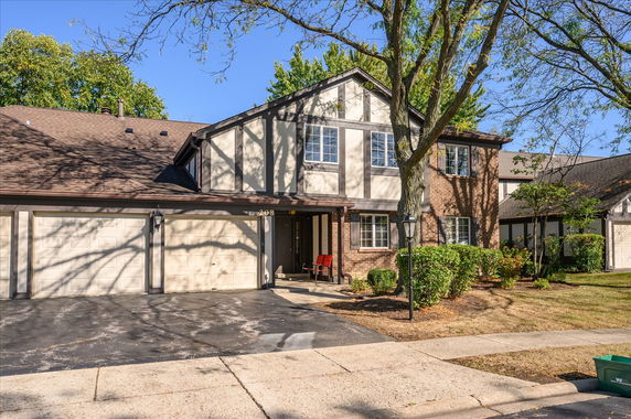 Front view of a two-story house with an attached garage.
