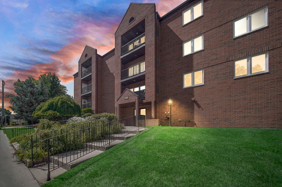 Front view of a multi-story brick building with balconies.