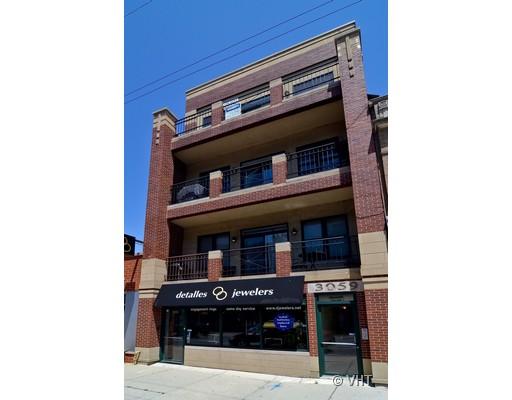 Front view of a multi-story building with a commercial space on the ground floor.