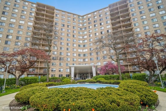 Exterior view of a multi-story apartment building with balconies.