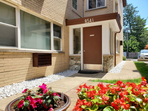 Front view of a building entrance with brick exterior and door labeled 8541.