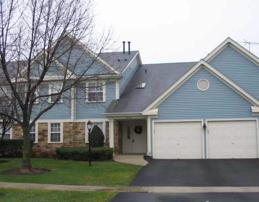 Front view of a two-story house with a double garage and blue siding.