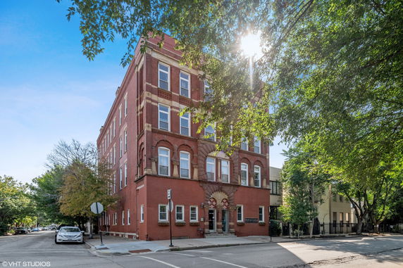 Front view of a multi-story brick building with decorative architectural details.